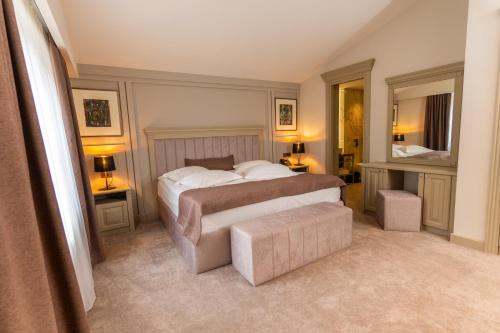 a bedroom with a bed and two tables and two lamps at Hotel Dilijan Resort in Dilijan