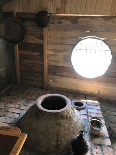 a room with a large tub with a window at Dogurashi Turbaza in Tsʼageri