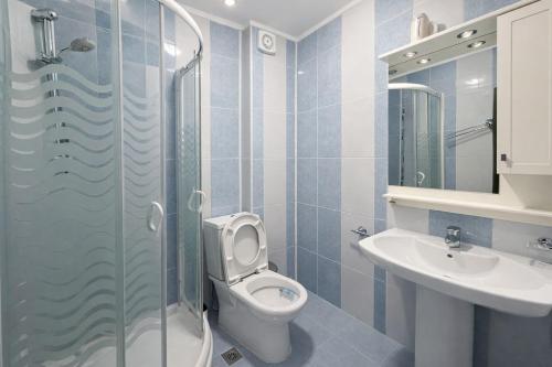 a bathroom with a toilet and a sink at River Park Oasis apartment in Sandanski