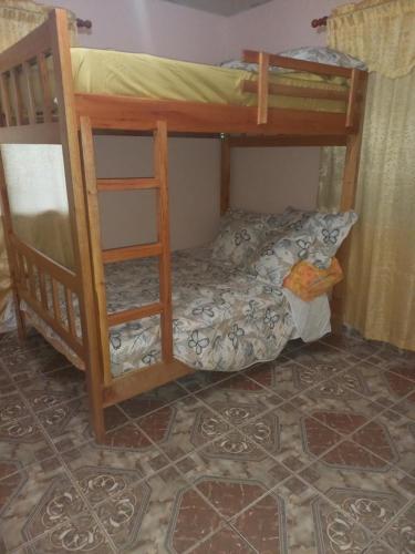 a bedroom with two bunk beds in a room at Affordable Spacious Studio Apartment in Nueva California