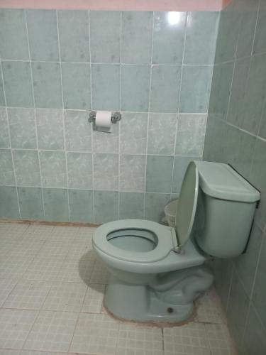 a bathroom with a toilet and a roll of toilet paper at Affordable Spacious Studio Apartment in Nueva California