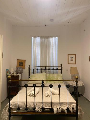 a bed in a bedroom with a window at Traditional Detached House in Spetses