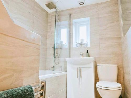 a bathroom with a toilet and a sink at St Helens 3BR Home with Garden, Fast WiFi, Smart TV, Sleeps 6, Contractors & Long Stay Accommodation in Saint Helens
