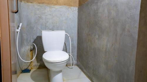 a bathroom with a white toilet in a room at Sigiri Jungle Camping in Sigiriya