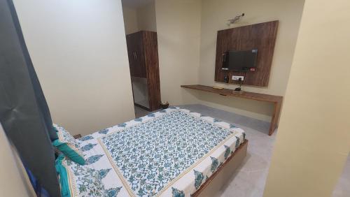 a bedroom with a bed and a tv in it at Hotel Anmol&Rooms in Gothaj
