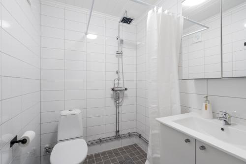 a bathroom with a shower and a toilet and a sink at Linneby in Uddevalla