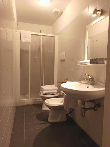 a bathroom with a sink and a toilet and a mirror at Villa Al Piano in Lastra a Signa