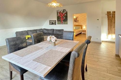 a dining room with a table and a couch at Luftschloss Baum 6 in Burg