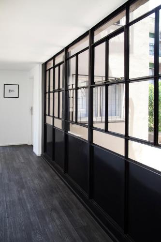 an empty room with large windows in a building at Hotel Alto San Isidro in San Isidro