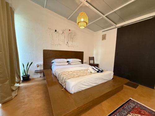 a bedroom with a large bed in a room at Anexx Goa in Vagator