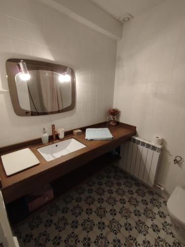 a bathroom with a sink and a mirror at Cozy rural apartment in Calaceite