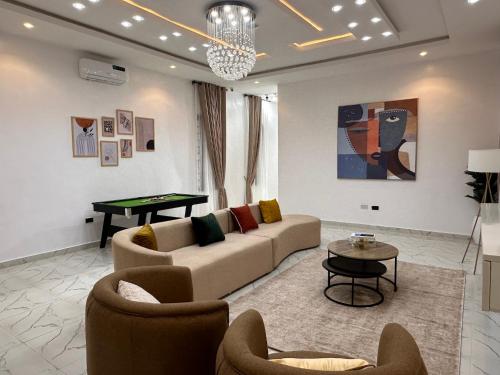 a living room with a couch and a table at Tranquil Residences - Orchid, Lekki in Lekki