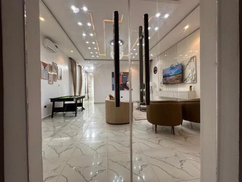 a room with a pool table and a dining room at Tranquil Residences - Orchid, Lekki in Lekki