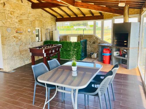 a patio with a table and chairs and a kitchen at Lourença Stays - Quinta Lourença in Vilar