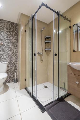 a bathroom with a shower and a toilet at Blue Waves 2 Bedrooms with Pool in Bouznika