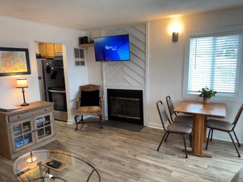 a living room with a fireplace and a tv on the wall at Sugar Ski & Country Club in Sugar Mountain