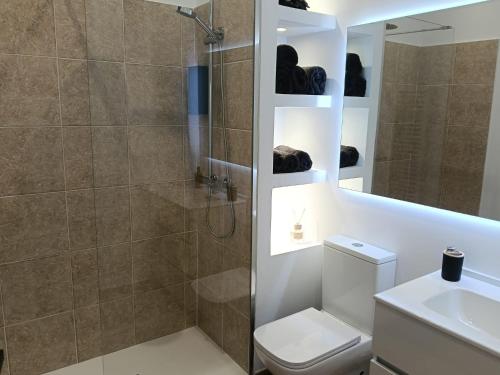 a bathroom with a shower and a toilet and a sink at Can Masia in Olivella