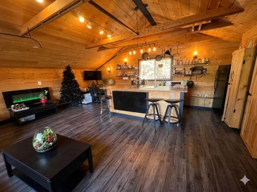 a kitchen and living room with a christmas tree in a cabin at Charming "Melrose Place" w Year-Round Heated Pool, Deck & Grill in Victoria