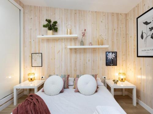 a bedroom with a white bed with two tables at Vivienda del mar in Arico