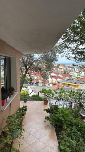 a balcony with plants and a view of a city at Kapllani Guest House in Durrës