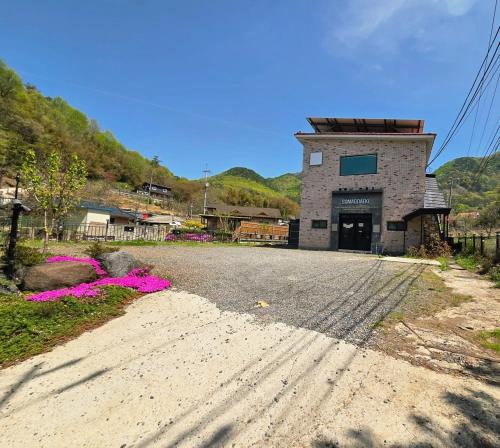 a building on the side of a dirt road at Okcheon Somakdaegi Pension in Okcheon