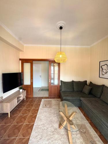 a living room with a couch and a table at Dina Apartment in Ágios Rókkos