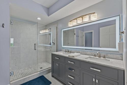 a bathroom with a double sink and a shower at Wicked Fun at Windswept Ridge in Corolla