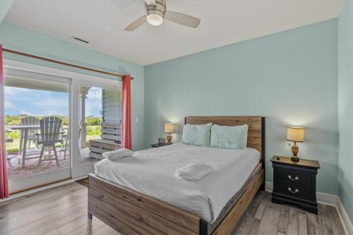 a bedroom with a bed and a balcony at Wicked Fun at Windswept Ridge in Corolla