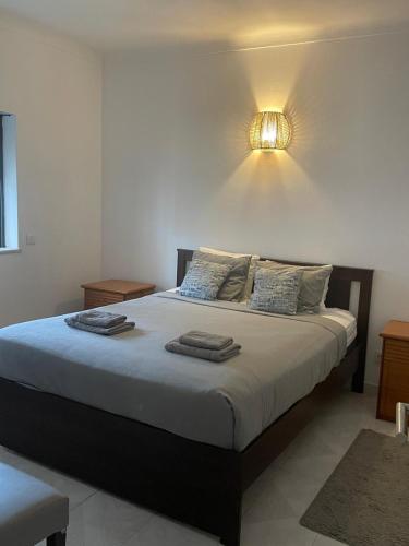 a bedroom with a bed with a light on the wall at Large 2 bedroom Lagos apartment in Lagos