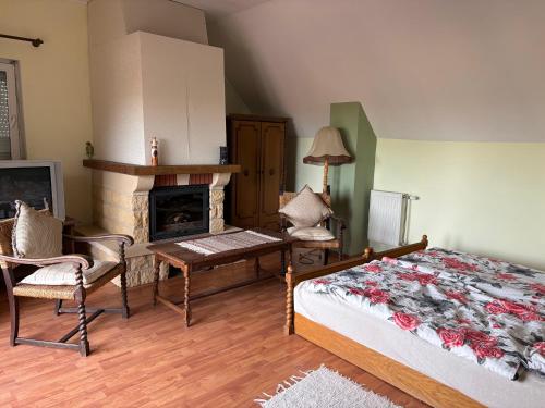 a bedroom with a bed and a fireplace at Valéria Vendégház in Budakalász