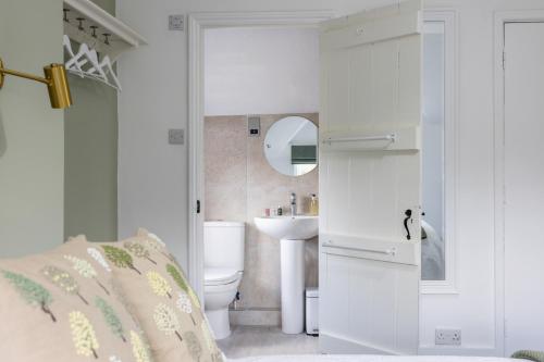 a bathroom with a toilet and a sink at The Ash Tree in Ashendon