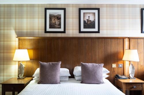 a hotel room with a bed and two lamps at Beaufort Hotel in Inverness