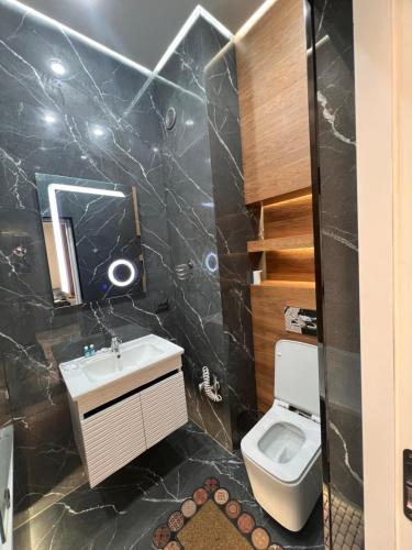 a bathroom with a sink and a toilet at Rakhim bobo 2 in Bukhara
