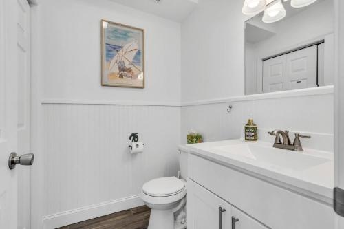 a white bathroom with a toilet and a sink at Coffee | Streaming TV | Fast WIFI | Pet Friendly in Seaside Heights