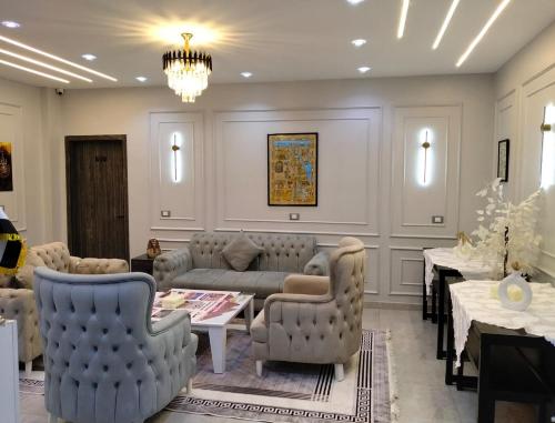 a waiting room with couches and tables and a chandelier at Karma Cairo Hotel in Cairo