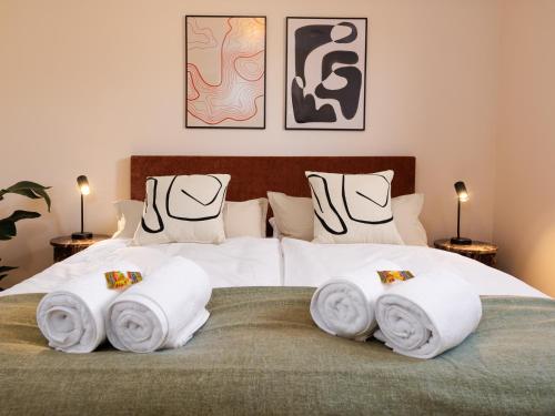 a bedroom with a bed with towels on it at PLEIB COLOGNE - Premium Suites in Cologne