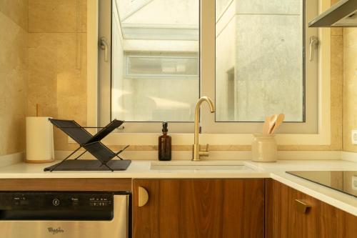 a kitchen with a sink and a window at Casanova Seaside in Porto
