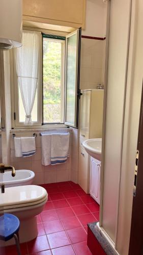 a bathroom with a white toilet and a sink at WELCOME - Scilla Casa Vacanze in Scilla