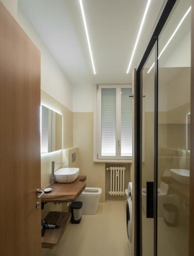 a bathroom with a sink and a toilet at Antonio Rooms 2 in Parma