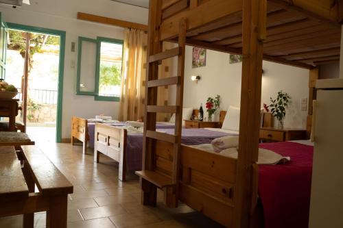 a bedroom with two bunk beds and a desk at G&P Rooms Matala in Matala