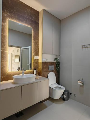 a bathroom with a sink and a toilet at Motel Adut Boleč in Donja Kapija