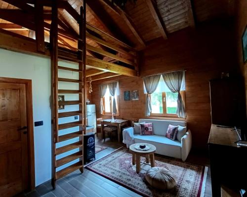 a living room with a couch and a table at Lorraine's cabin Plitvice in Drežnik Grad