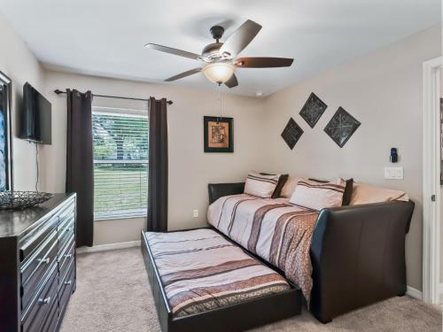 a bedroom with a bed and a ceiling fan at Ocala Oasis 3 bedroom in Ocala