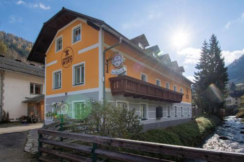 a building with a balcony on the side of it at Gasthof zum Hammer in Göstling an der Ybbs