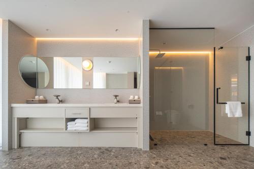 a bathroom with a sink and a mirror at Leston Hotel in Bangkok