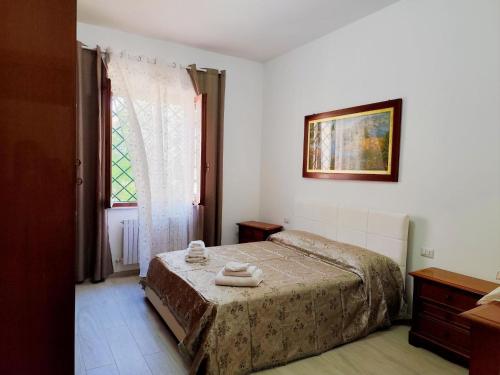 a bedroom with a bed with two towels on it at Casa della Fiera 9 in Narni