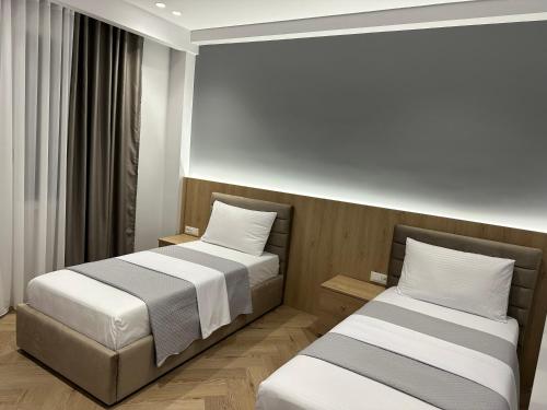 two beds in a small room with at Villa Billa in Tirana