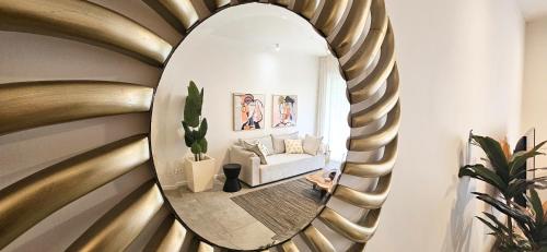 a person sitting in a living room with a mirror at Tropical - Resort - Spa - Pool & Garden in Grand-Baie