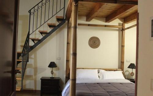 a bedroom with a large bed with a staircase at Porta di Mare in Sciacca