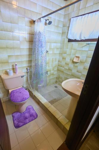 a bathroom with a shower and a toilet and a sink at Cutie 3 br Villa Nyali in Mombasa